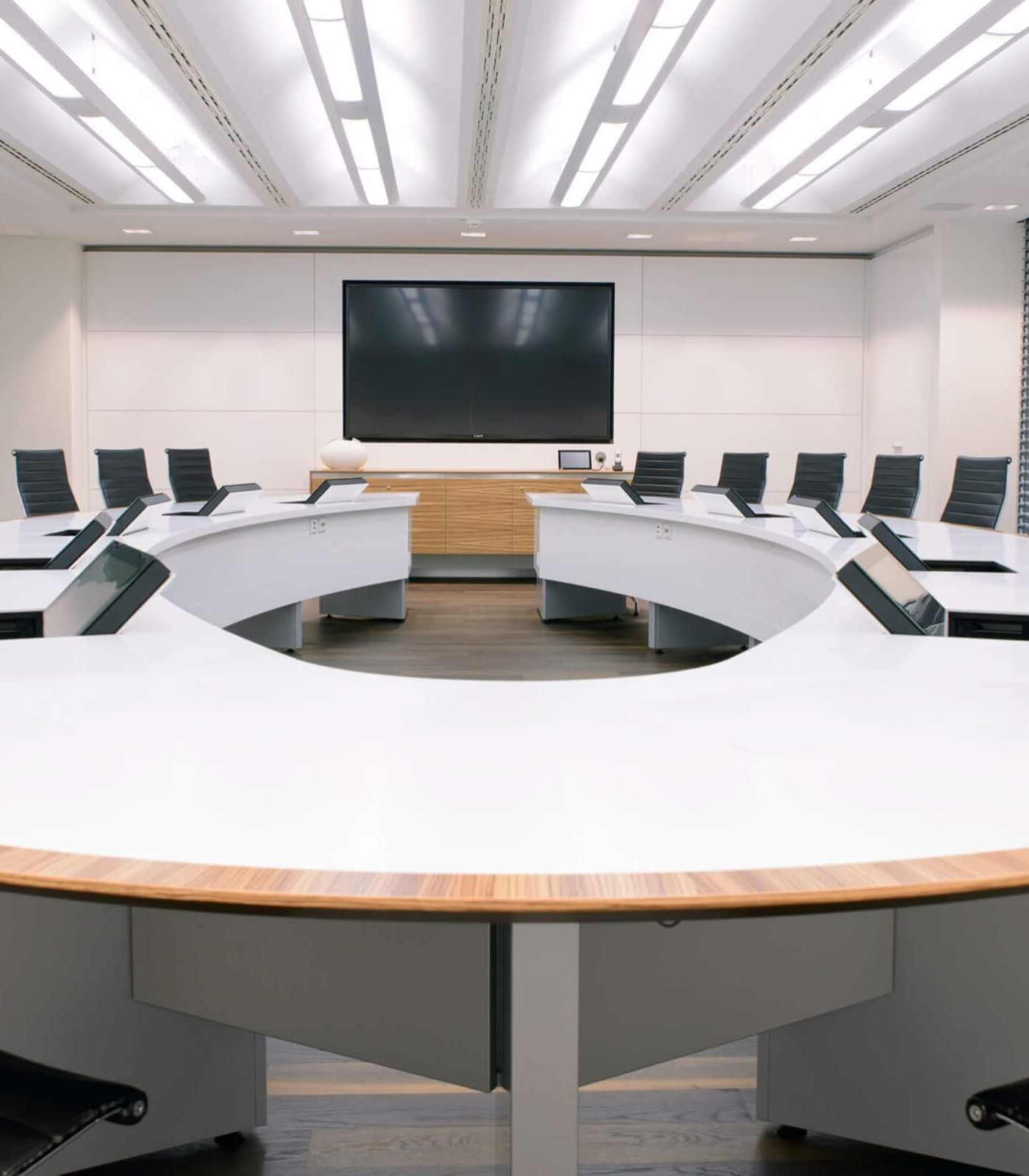 Noll integrates hinged and retractable monitors in the conference room