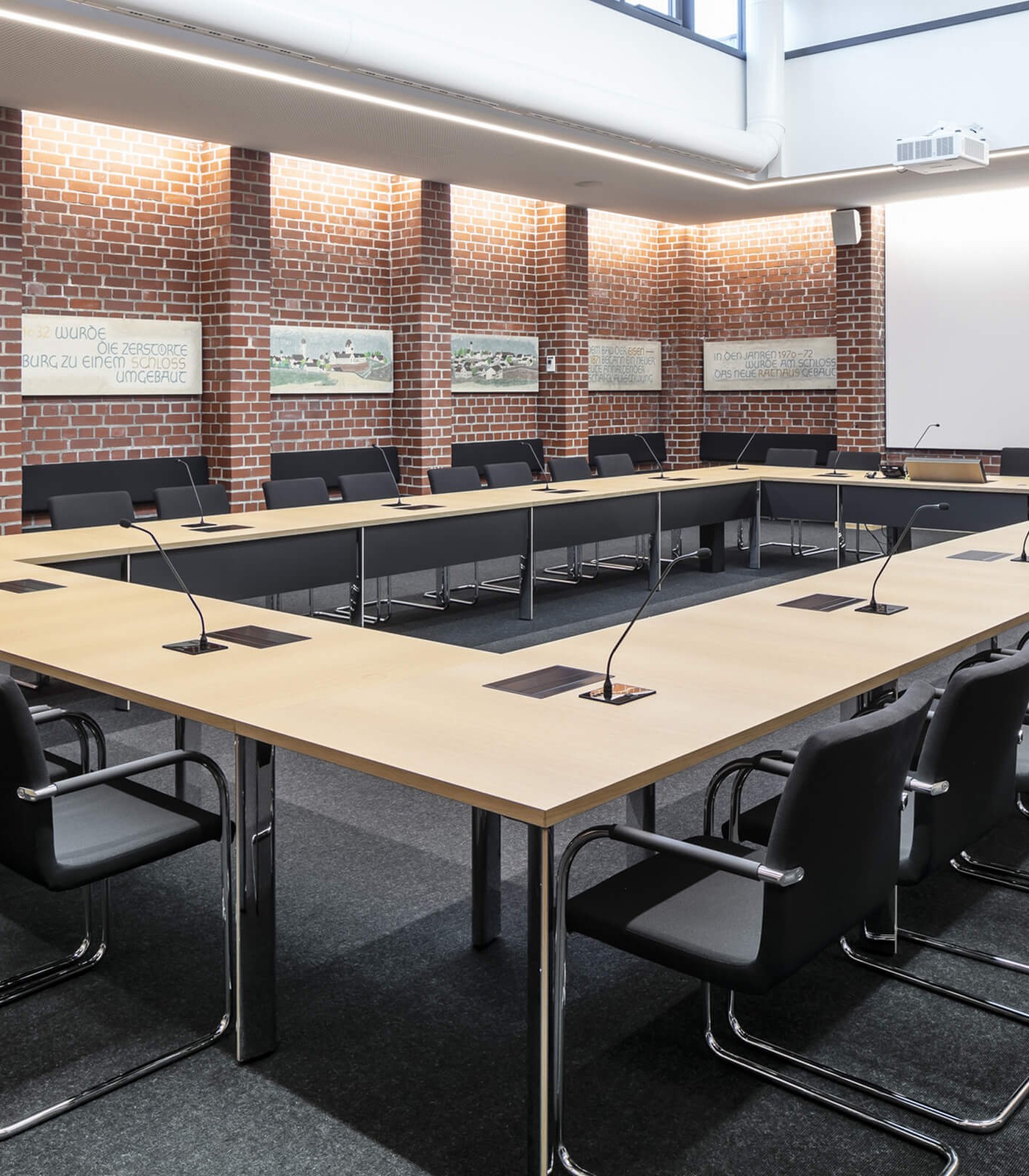 A conference table with integrated screens.