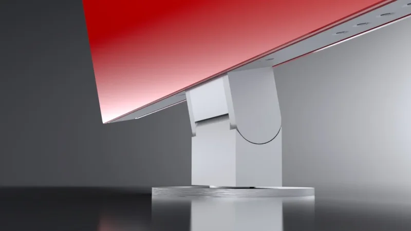 Close-up view of the base of the desktop monitor with integrated cable management