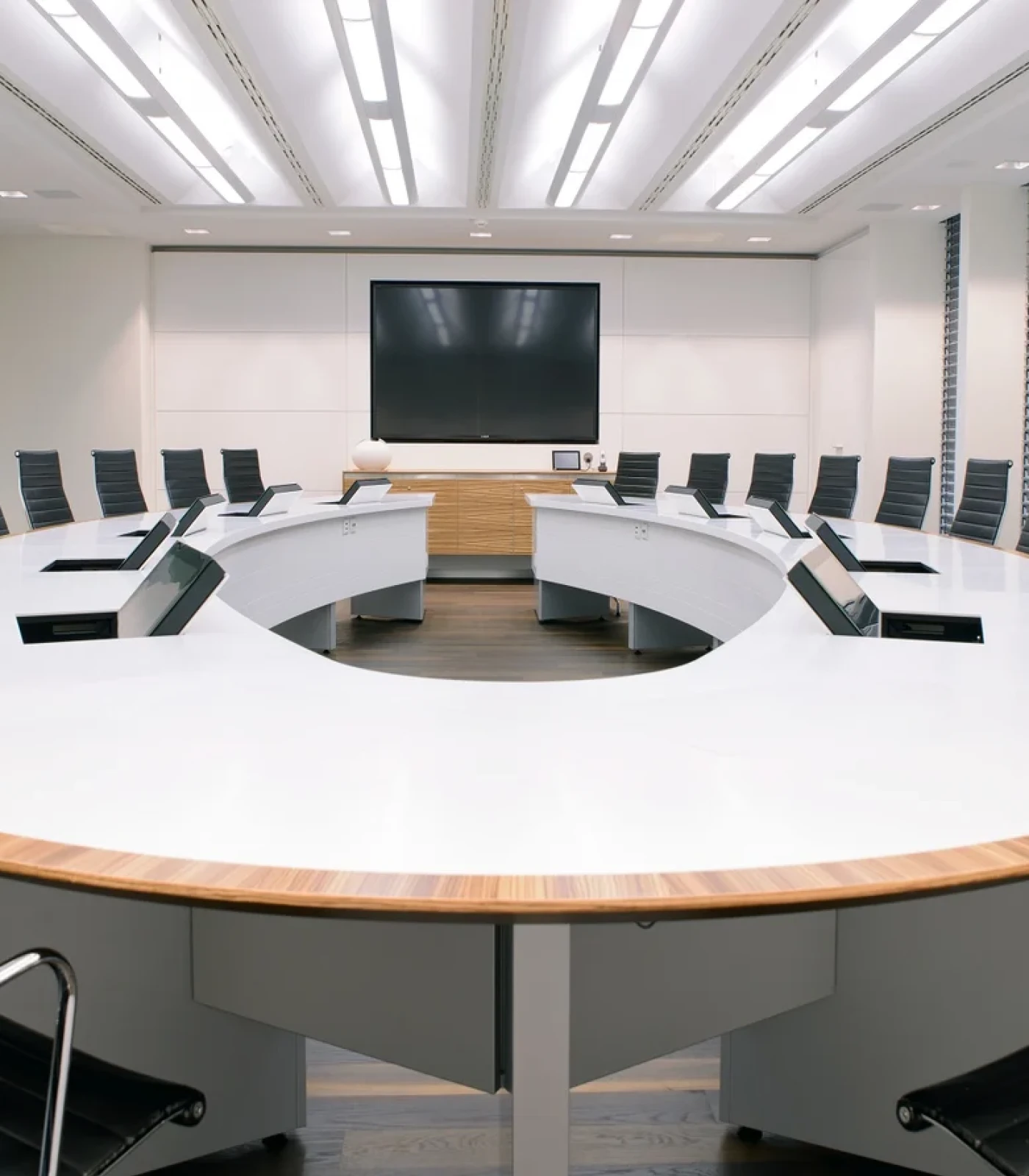 Seamlessly integrated. The LOFT fold built-in monitor in a modern conference room.
