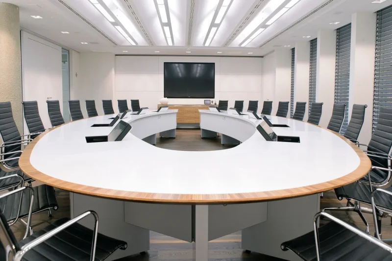 Seamlessly integrated. The LOFT fold built-in monitor in a modern conference room.