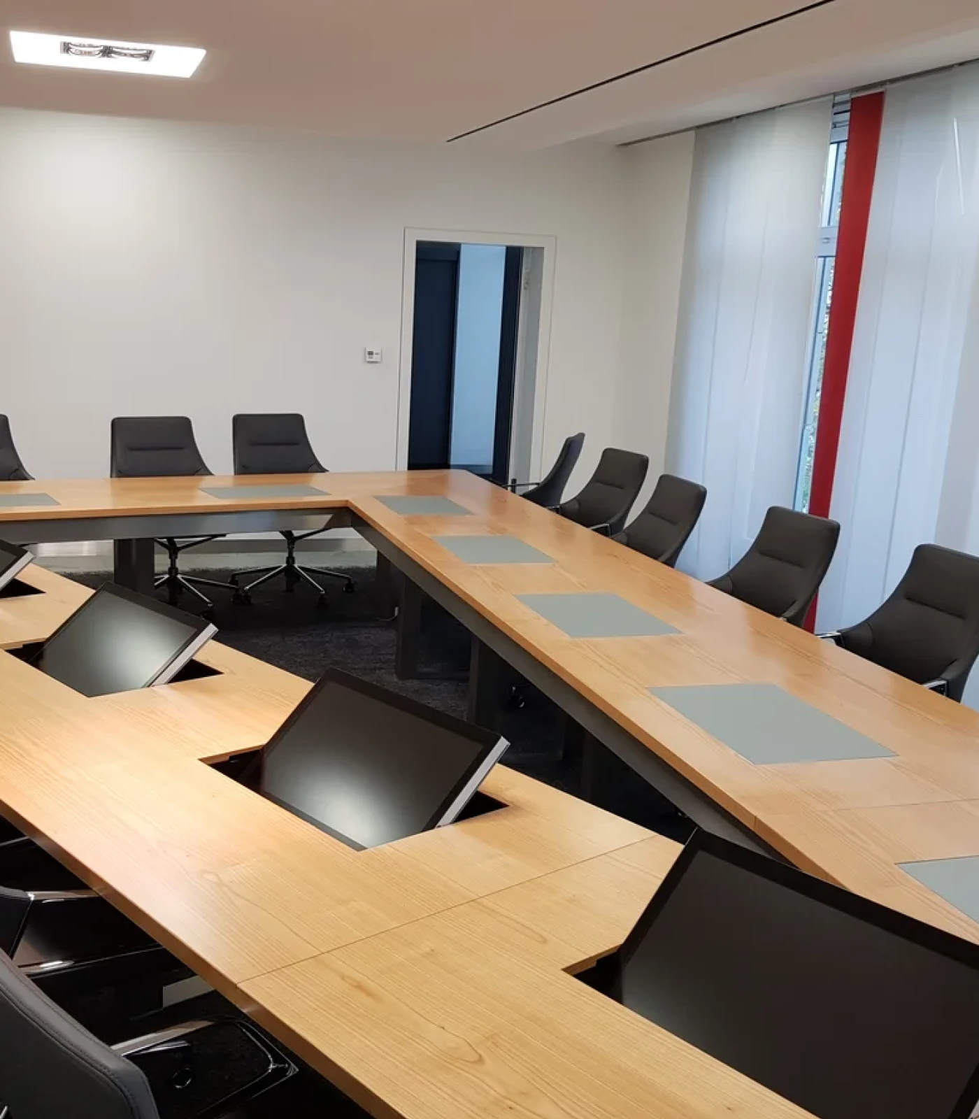 Conference room featuring an innovative built-in table monitor from Novis for modern and smart conferences