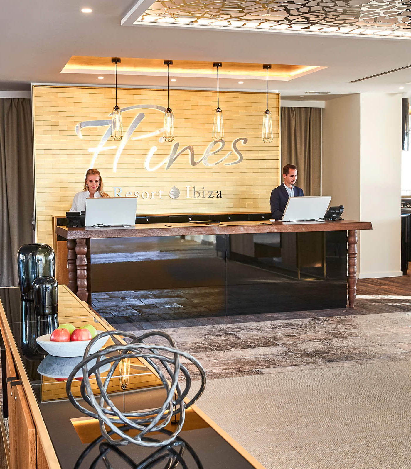 Arrivals area at 7 Pines in Ibiza. The FLO EVO Design Monitor welcomes visitors in understated white