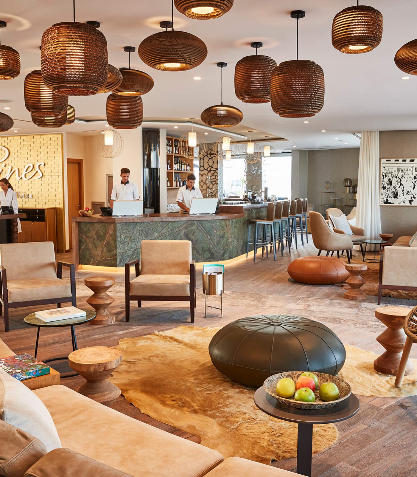An impressive hotel lobby at 7 Pines in Ibiza. The hotel counters are adorned with our FLO EVO tabletop monitor in white.