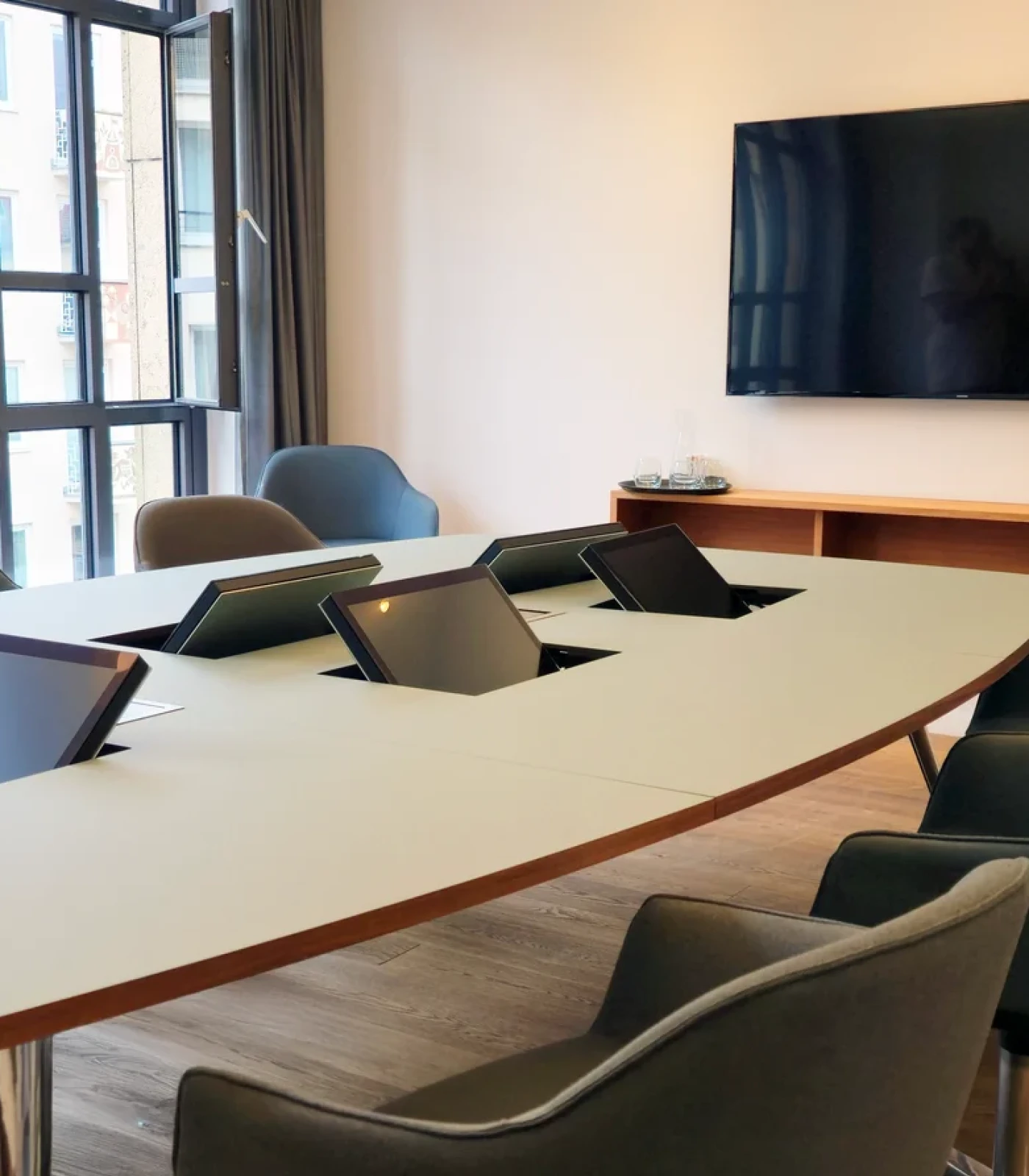 The retractable monitor in a notary desk, open. A screen at every seat, everything perfectly in view